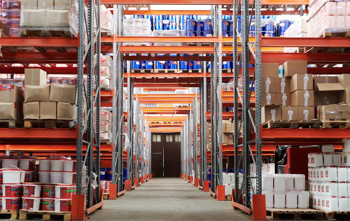 Warehouse shelving with stocked goods, representing logistics and supply chain operations